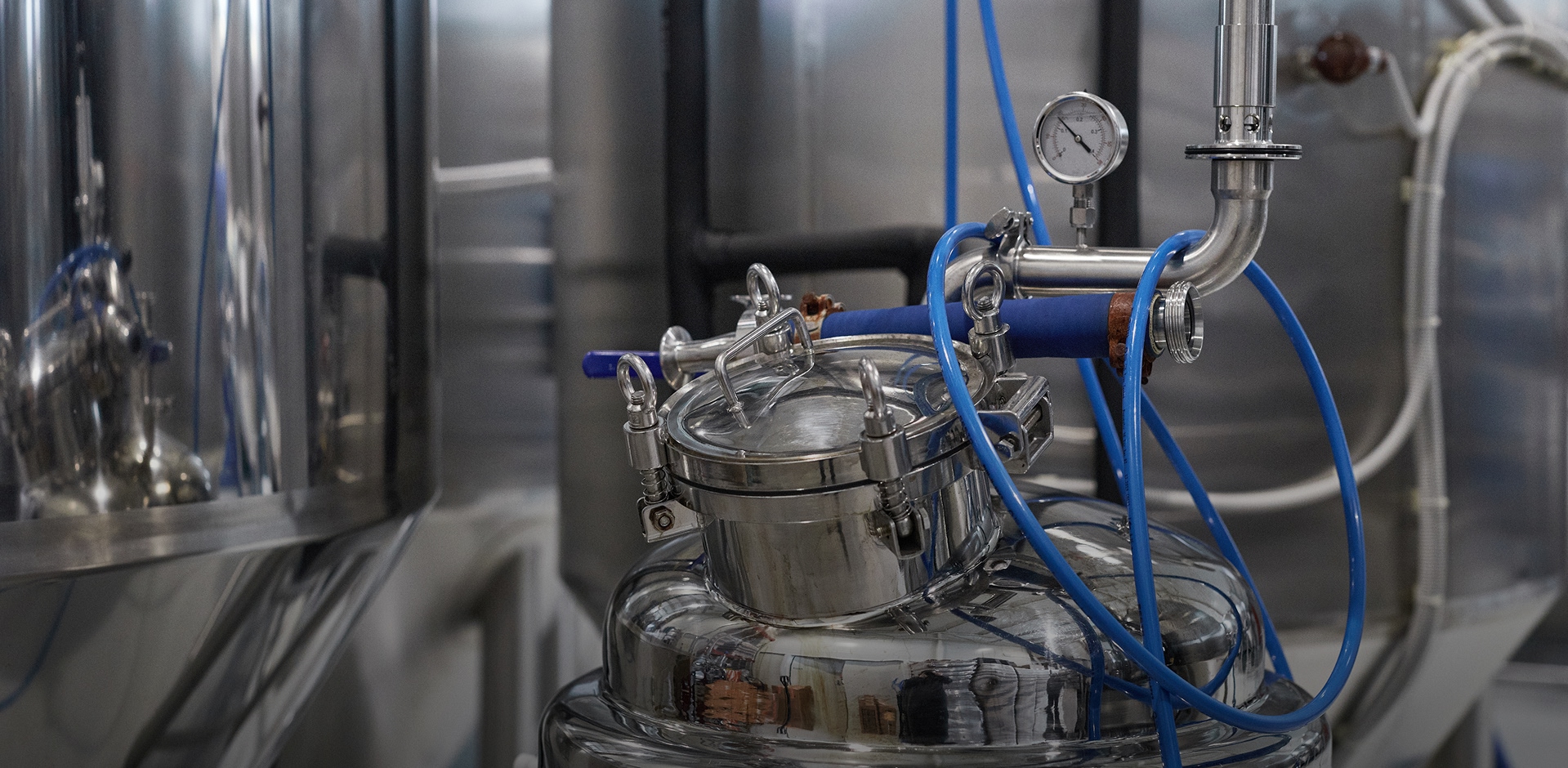 Industrial vacuum equipment featuring stainless-steel chambers and processing pipelines.